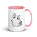 White mug with pink interior and handle, featuring a cute blue-eyed ragdoll cat graphic